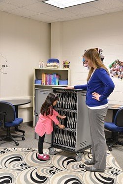 Image of student and teacher using the Spectrum Charging Cart in a classroom