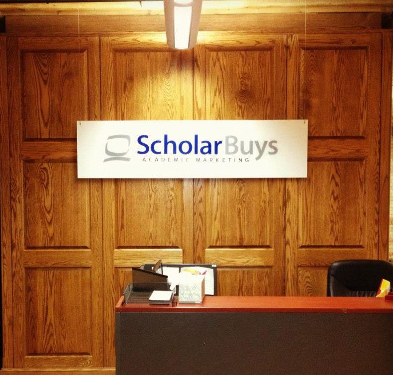 Image of ScholarBuys front desk and logo