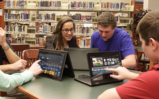 Image of students using Chromebooks in the school library